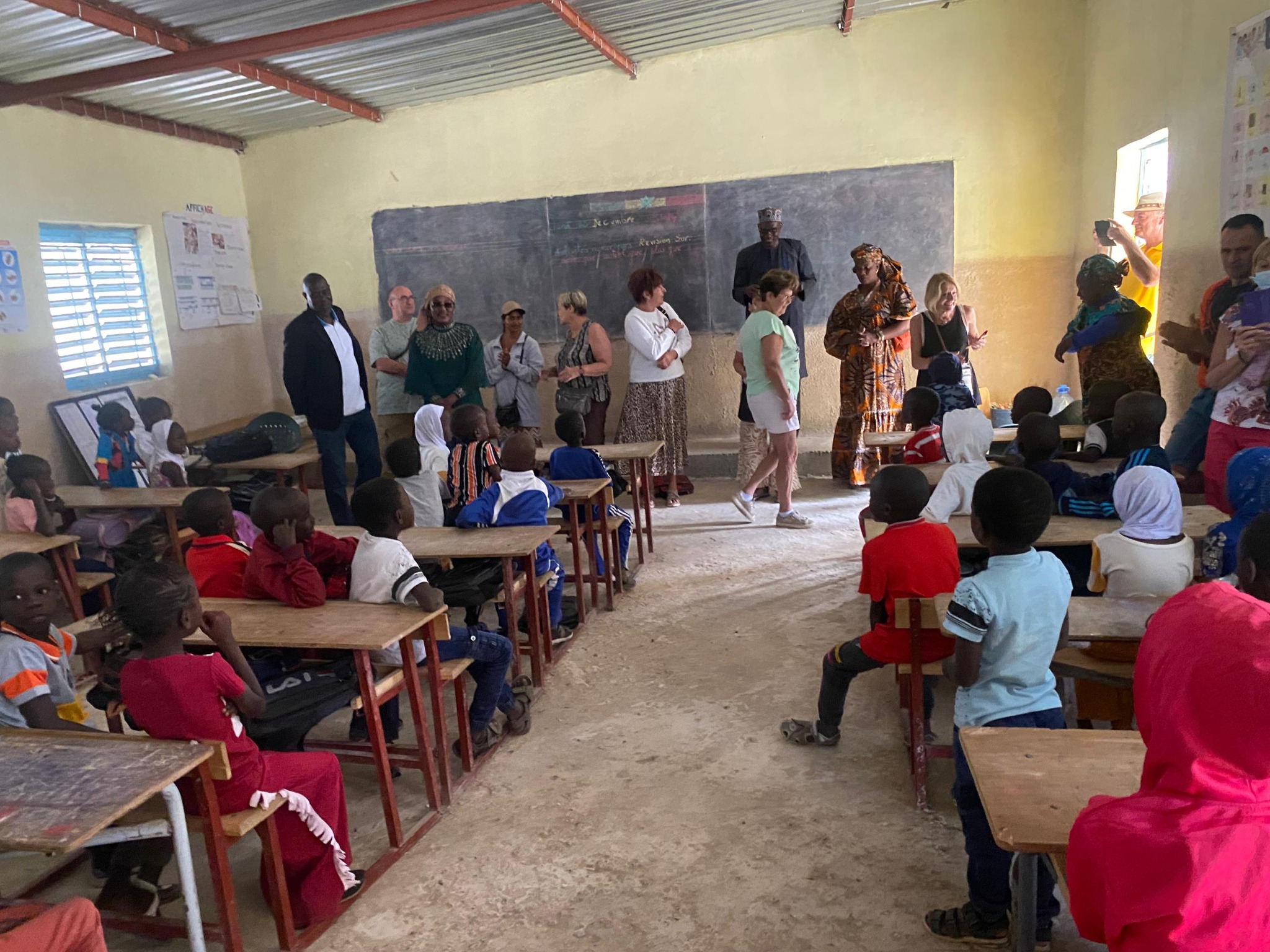Visiteurs et élèves dans une salle de classe au Sénégal